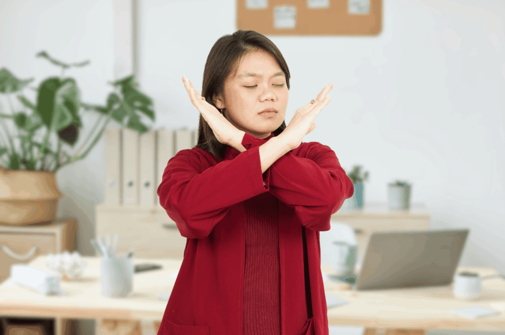Person crossing arms illustrating confidence and professionalism for the red flags that one should look for when looking for a contractor