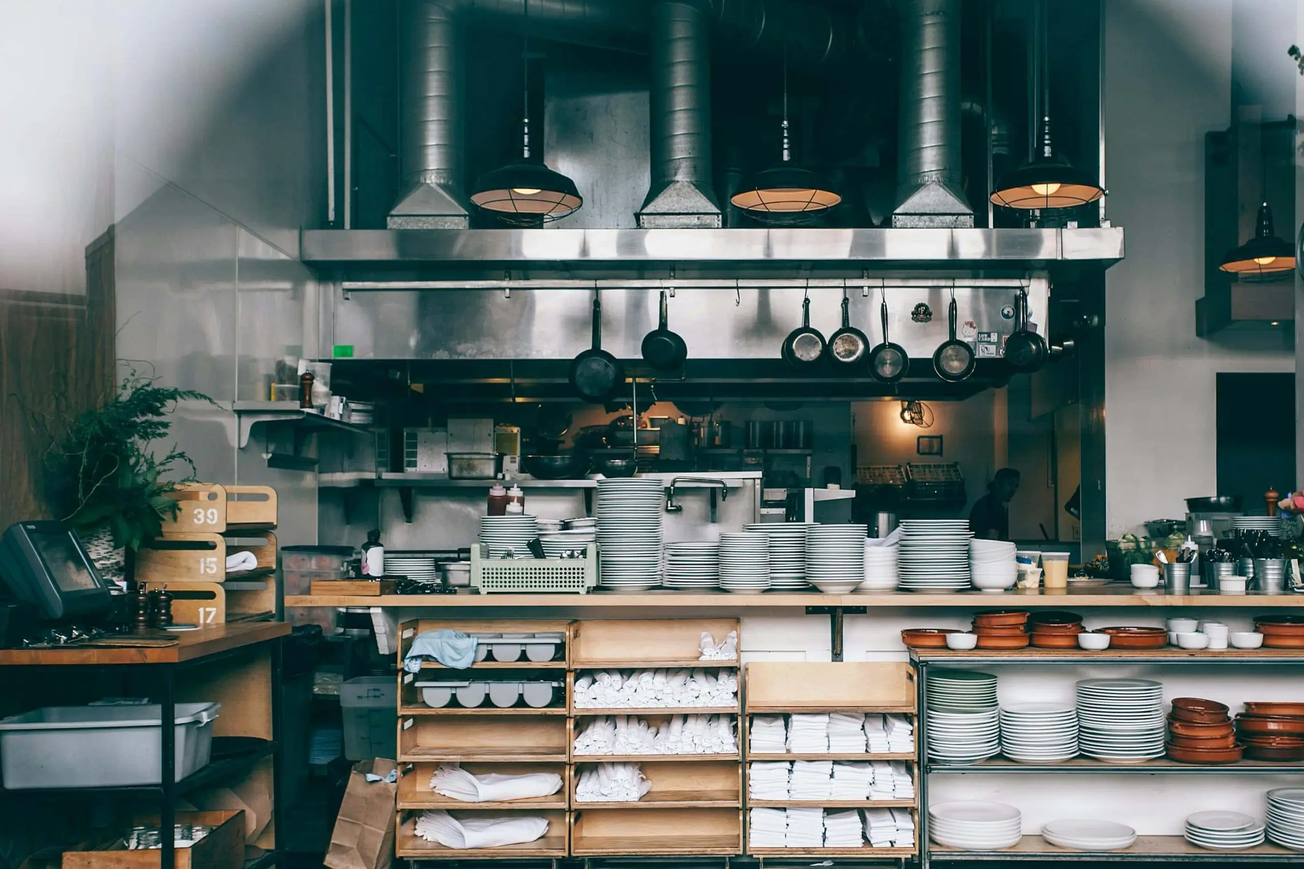 A wide shot of a clean restaurant kitchen, with all its equipment neatly stowed in their compartments.