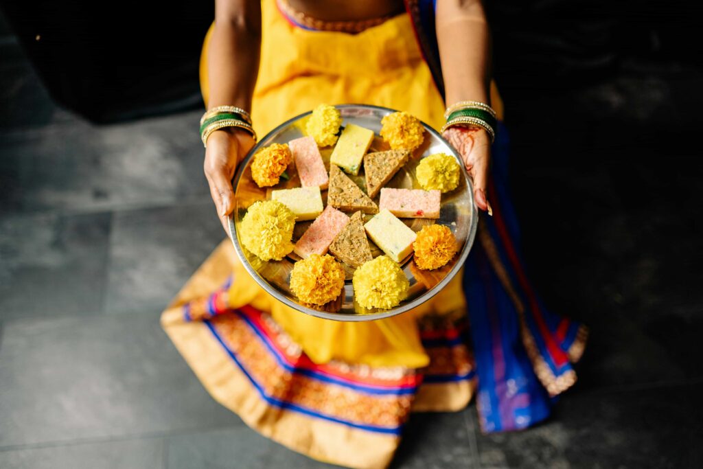 A photo that shows an example of a Hinduism food being served on a silver platter.