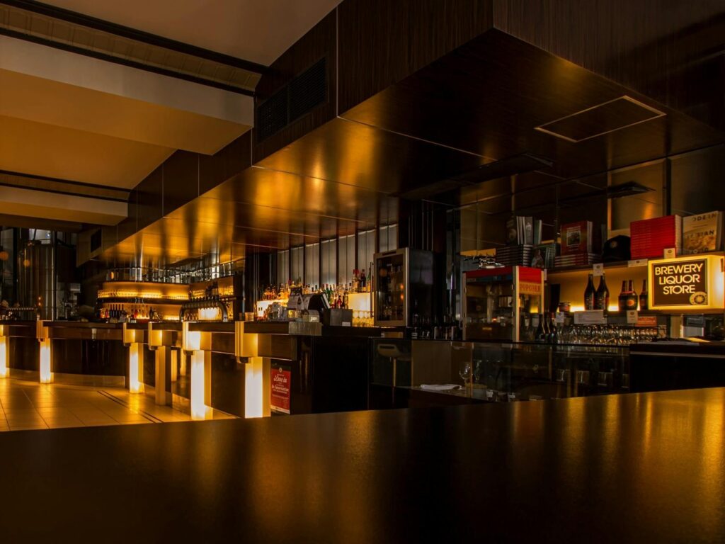 A dimly lit area in the restaurant with little lighting during evening hours.