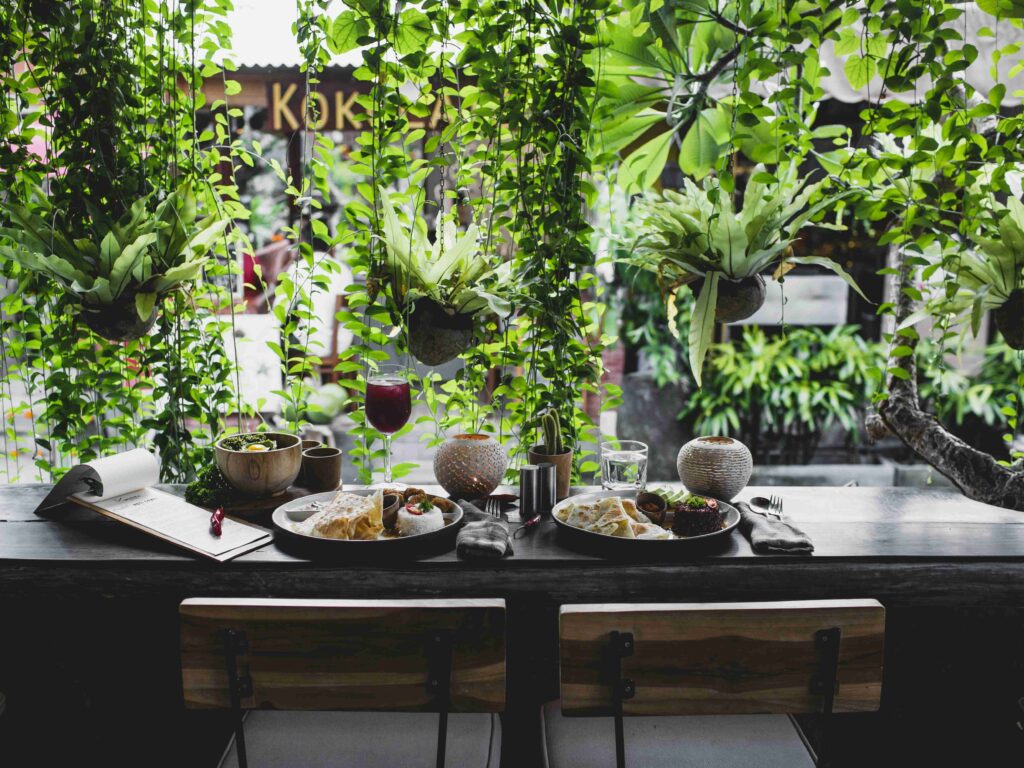 A table for two decorated with rich vines flowing down.