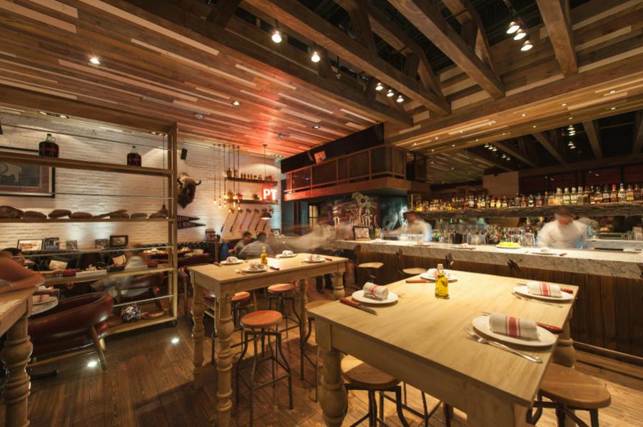 A restaurant interior where the guest can see the chefs as they prepare their meals and drinks as they dine.