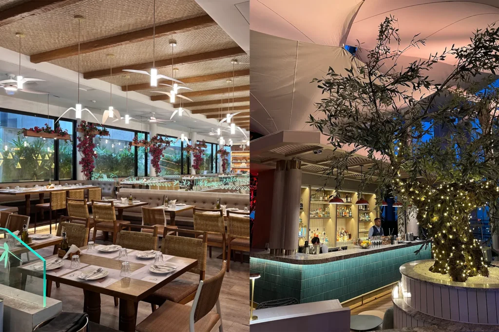 Split view of a modern Mediterranean restaurant showing a dining room with wicker ceilings and bird-shaped pendant lights next to a chic cocktail bar wrapped around an illuminated olive tree.