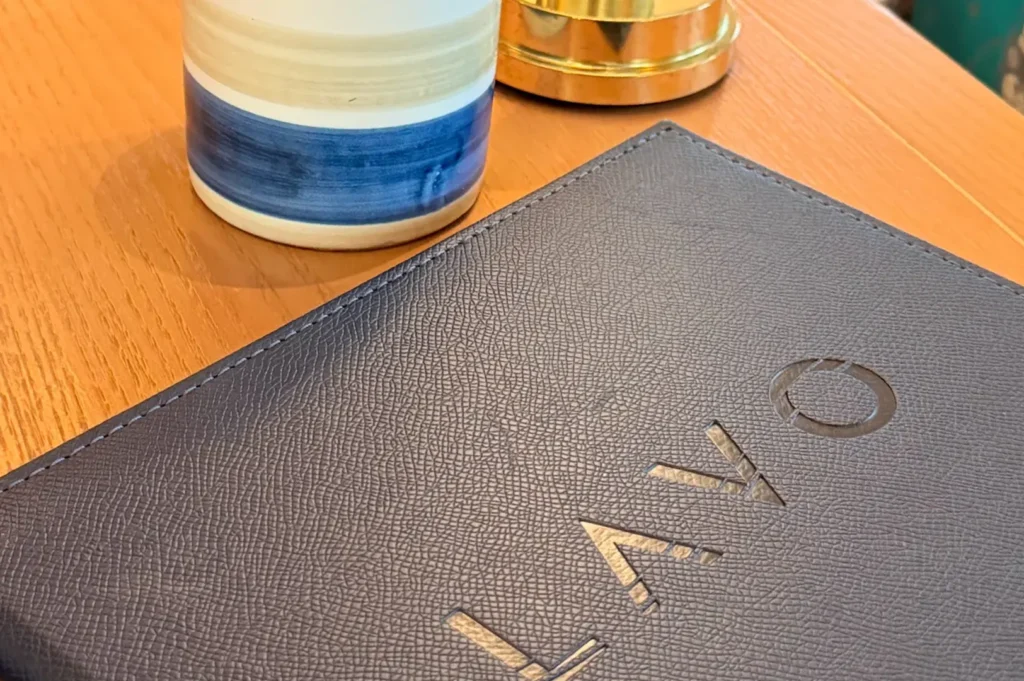 Textured leather menu cover with embossed logo at LAVO Italian Restaurant Singapore